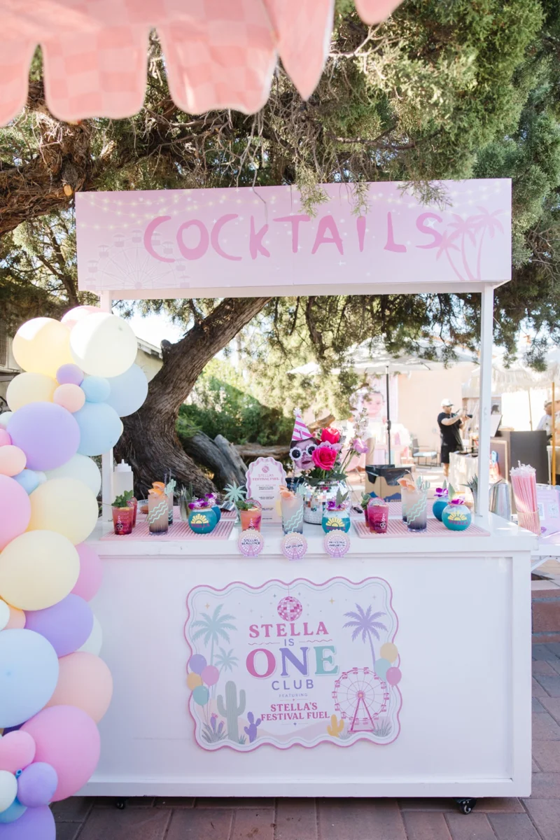 Pink cocktail bar with a striped canopy and pastel decorations