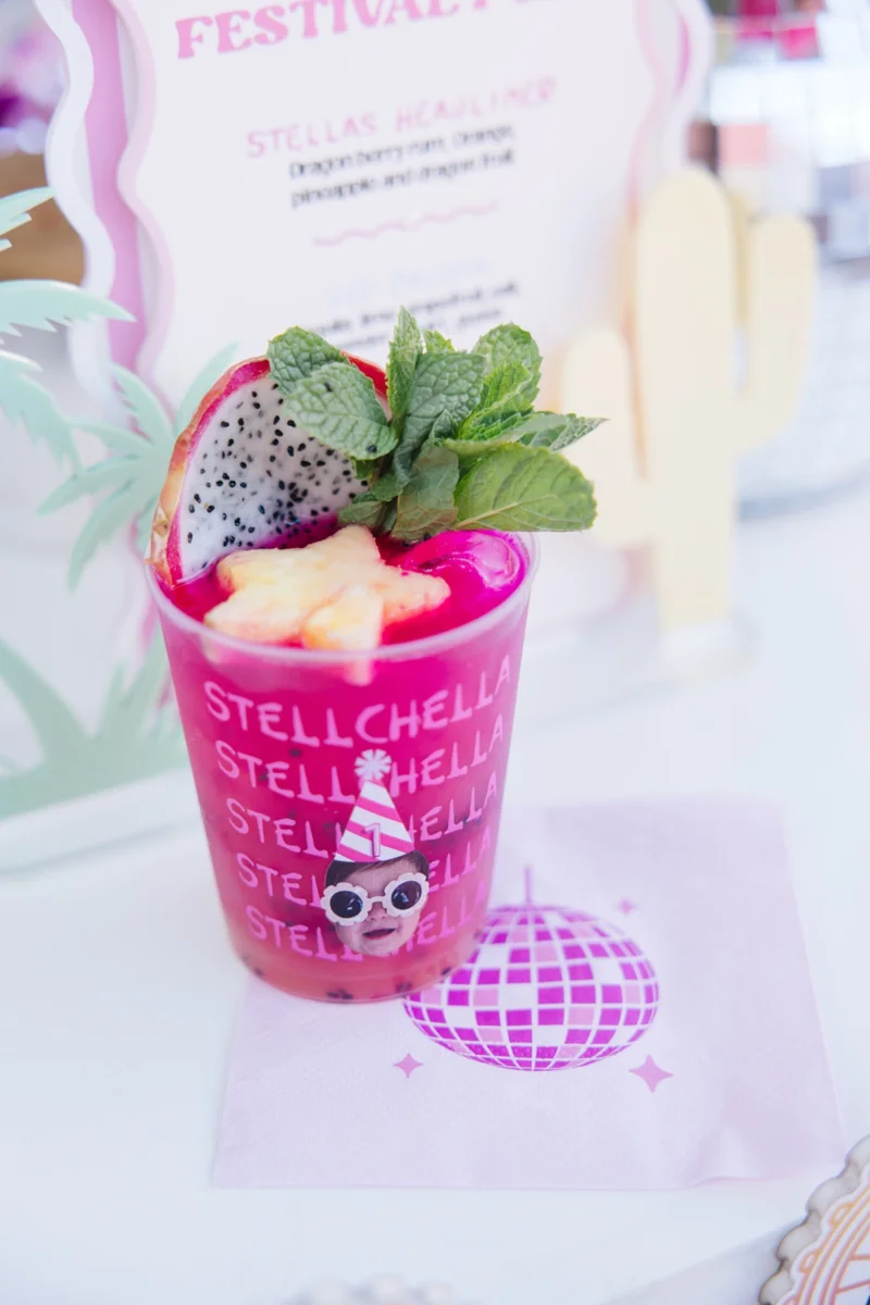 Bright pink cocktail with mint and dragon fruit garnish