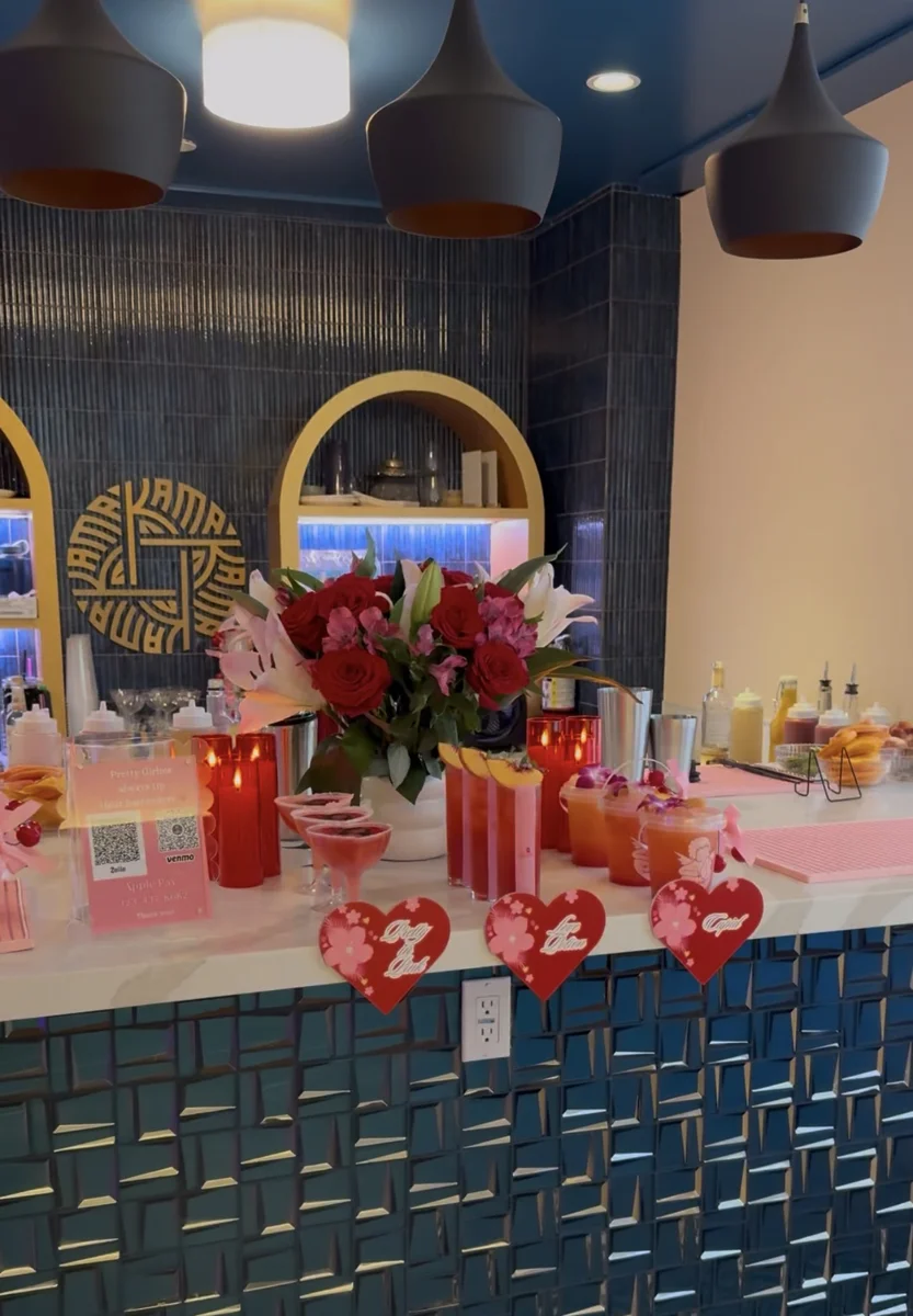 Cocktail bar setup with colorful drinks at an indoor event